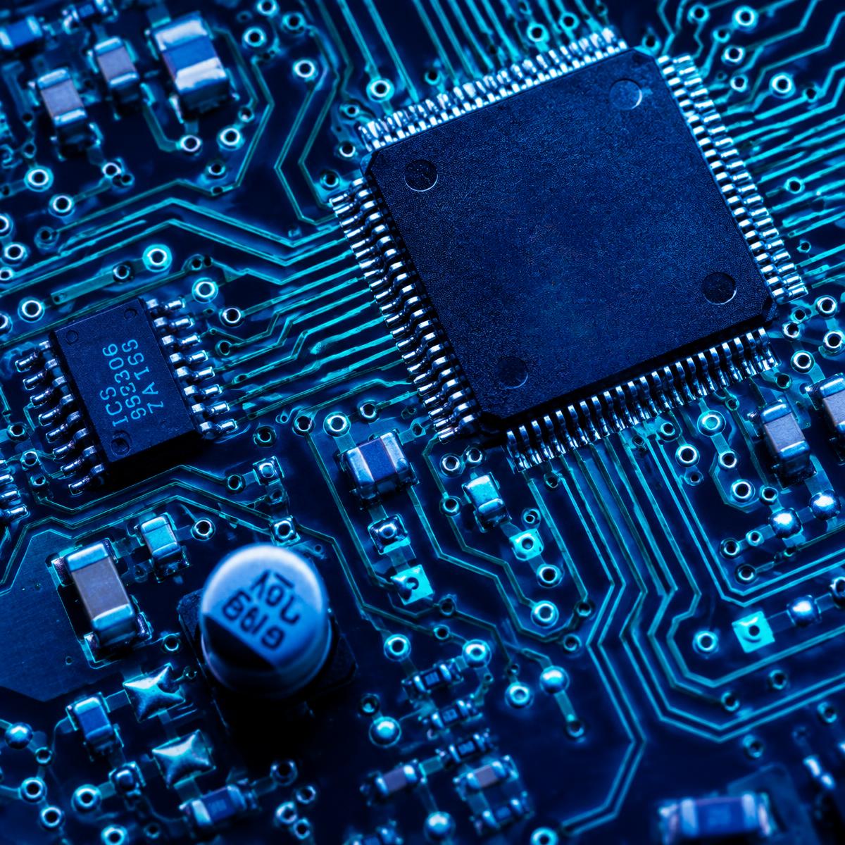 Macro view of a processor chip and copper traces on a circuit board